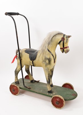 Lot 1000 - Large early 20th century child’s push along horse