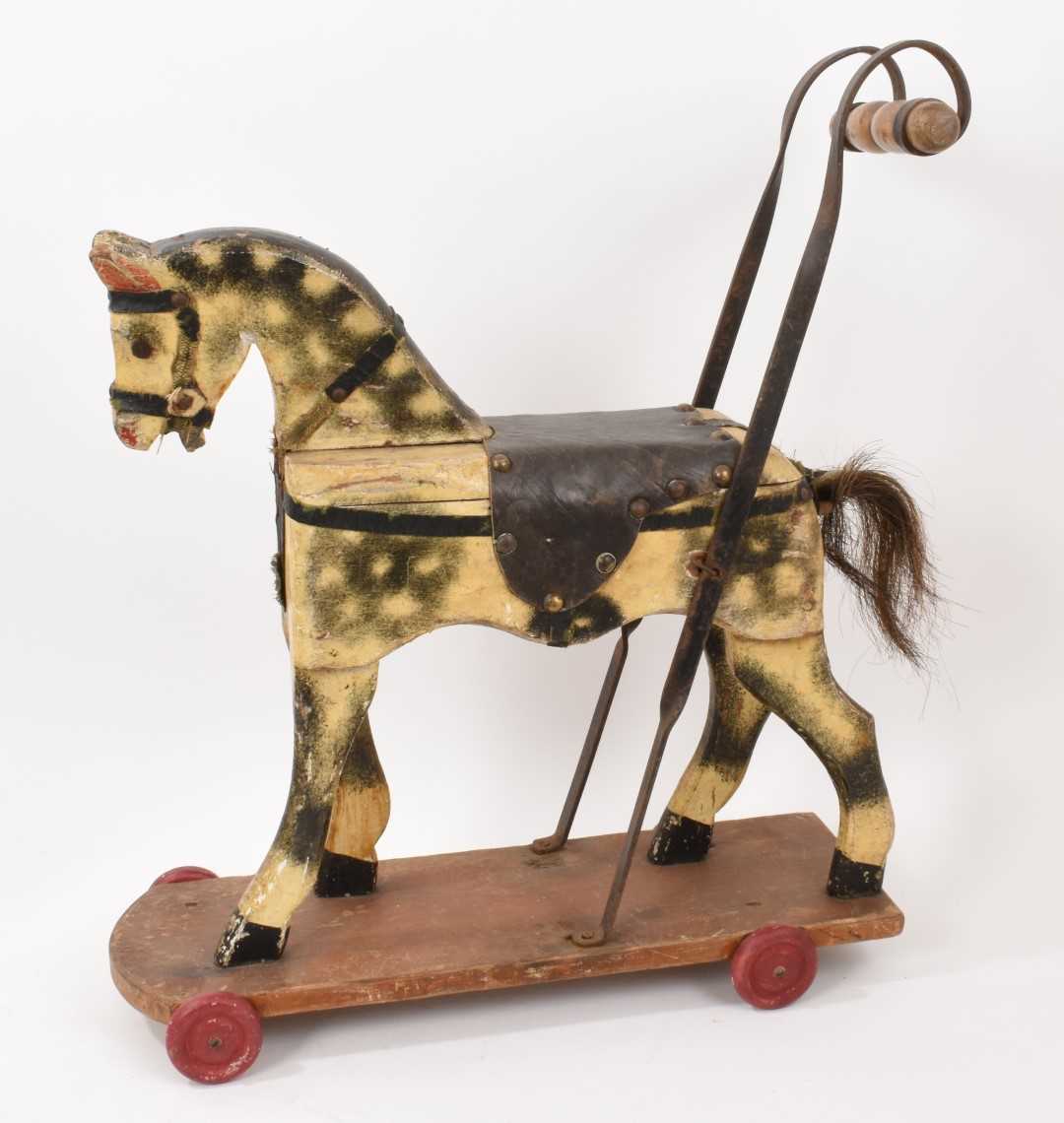 Lot 1001 - Early 20th century child’s push along horse