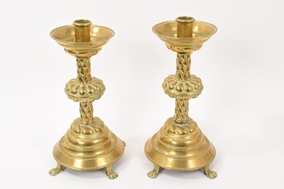 Lot 986 - Pair of 19th century gothic revival candlesticks, each of knopped gadrooned form on paw feet, 30cm high