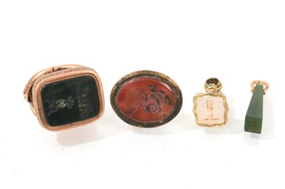 Lot 606 - Group of antique seals to include a Regency yellow metal seal with snake surmount and intaglio crest to the bloodstone seal, two gilt metal seals and a green hardstone seal (4)
