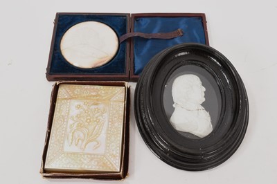 Lot 991 - Works of art including a mid 19th century carved mother of pearl card case, 10cm high, boxed, together with two relief portrait medallions. (3)