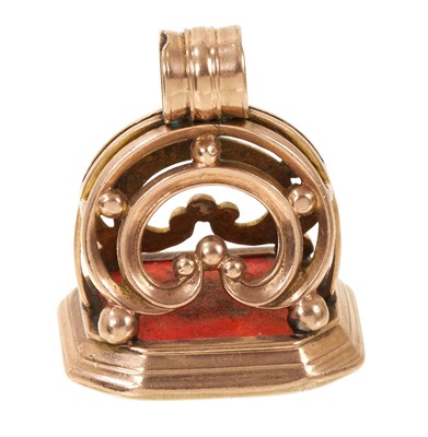 Lot 611 - Large Regency yellow metal seal, the octagonal carnelian seal with finely carved intaglio armorial crest, 32mm.