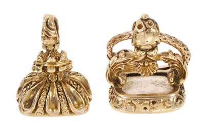 Lot 614 - Regency yellow metal seal, the chalcedony seal with intaglio carved family crest and motto, suspended from a Regency gold snake split-ring, together with another similar seal (2)