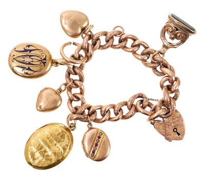 Lot 616 - Edwardian 9ct rose gold gate bracelet suspending five antique yellow metal lockets and a seal