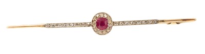 Lot 623 - Edwardian ruby and diamond bar brooch with a central oval mixed cut ruby surrounded by rose cut diamonds in platinum and gold setting, 65mm.