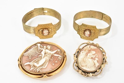 Lot 621 - 19th century Italian carved shell cameo brooch in yellow metal brooch mount, 65mm, another similar in gilt metal brooch mount and a pair of similar bangles (4)