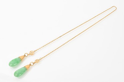 Lot 680 - Chinese gold and jade/green hardstone sautoir style necklace with chain links suspending two gold mounted jade/green hardstone drops, total length 57cm