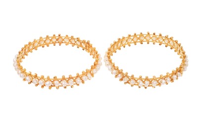 Lot 674 - Pair of Eastern gold and pearl bangles