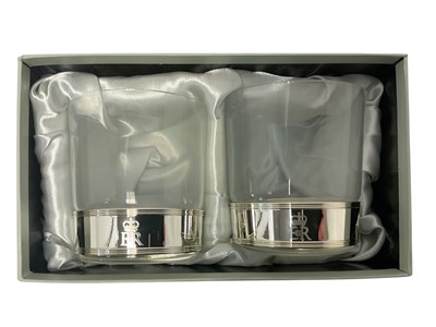 Lot 110 - H.M. Queen Elizabeth II, Royal Household 2010 Christmas gift pair of tumblers with silver plated bands decorated with crowned ERII cypher in box with card