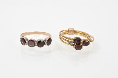 Lot 656 - George III garnet ring with four garnets in foiled closed-back setting on gold shank, ring size K, together with an antique diamond and garnet four...