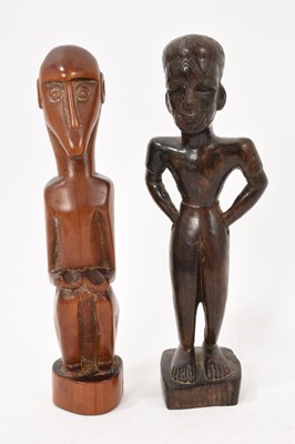 Lot 1116 - Two African carved wood figures, one in reddish wood and in the style of the 'Baboon Master', the other with carved pattern to the face, 21.5cm high