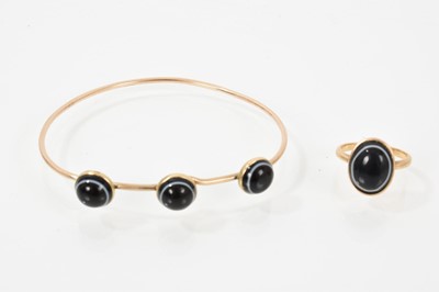 Lot 738 - Yellow metal bangle mounted with three round banded agate cabochons, together with a similar 9ct gold oval banded agate ring, size J½