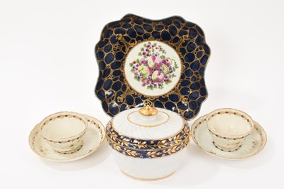 Lot 339 - A Worcester square scalloped dish, circa 1775, painted in the centre with spotted fruit, on a cobalt blue and gilt ground, ex-Albert Amor, 21.75cm across, together with two fluted Worcester tea...