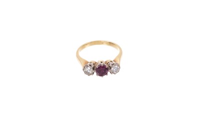 Lot 740 - Diamond and ruby three stone ring in 18ct yellow gold shank