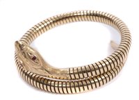 Lot 3200 - Gold (9ct) snake bangle with ruby eyes