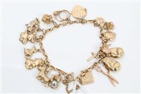 Lot 3204 - Gold (9ct) charm bracelet with various gold...