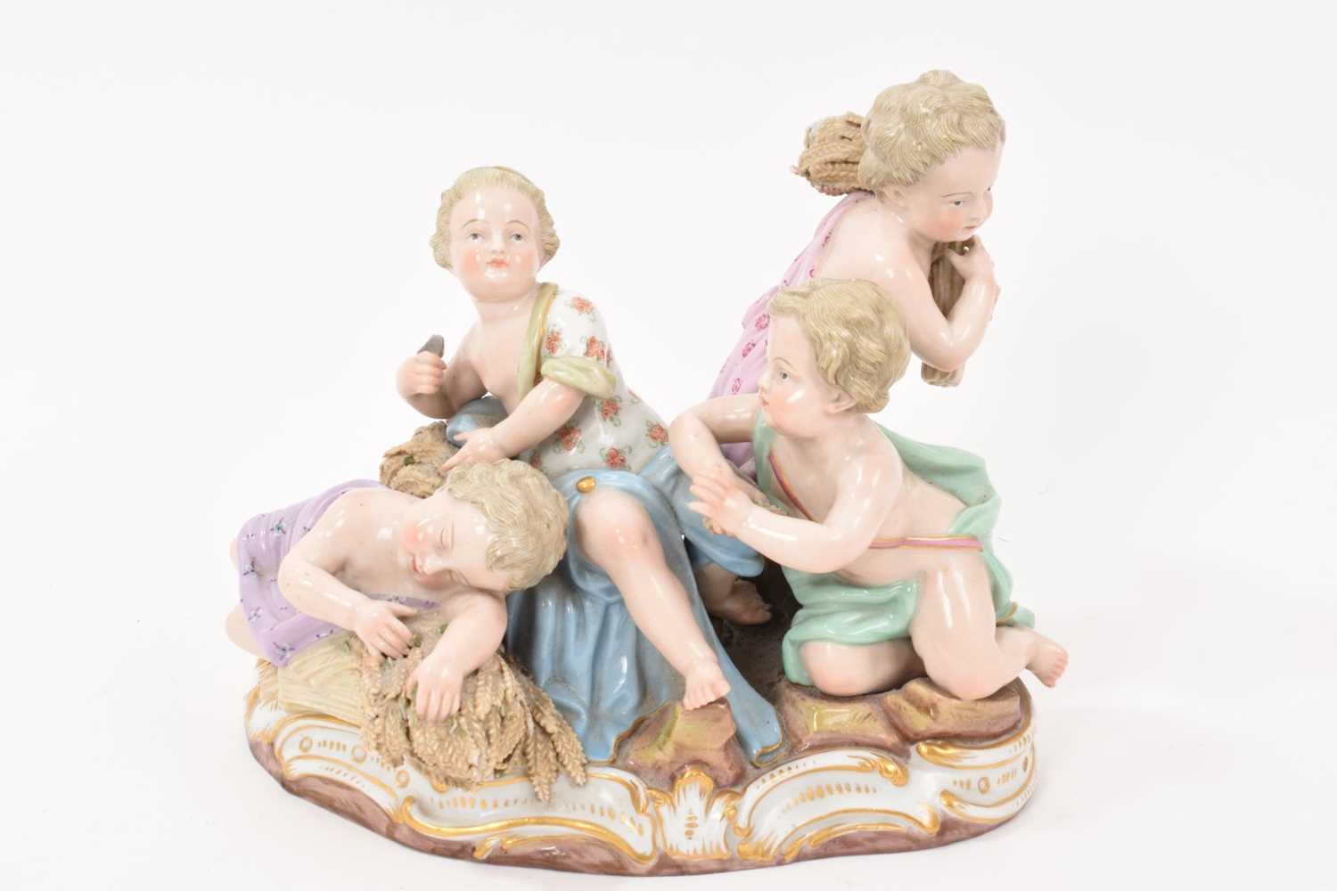 Lot 76 - 19th century Meissen figure group, an allegory of Summer, modelled with four figures carrying and resting on sheafs of wheat, crossed swords and incised model number '2490' to base, 16cm high<...