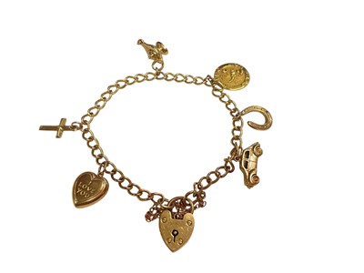 Lot 72 - 9ct gold curb link charm bracelet with padlock clasp and six 9ct gold novelty charms