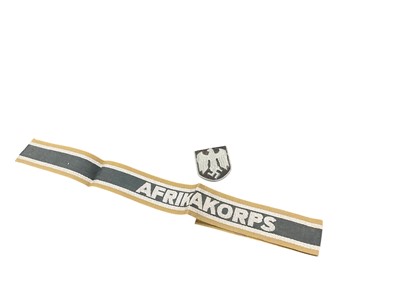 Lot 746 - Second World War Nazi German Afrikakorps cuff title, together with a Nazi cap badge, (2).