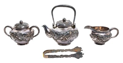 Lot 202 - Japanese silver three piece teaset and associated tongs.