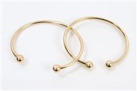 Lot 3232 - Two gold (9ct) torque bangles