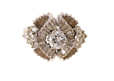 Lot 421 - Diamond cluster ring with a central brilliant cut diamond estimated to weigh approximately 0.80cts, surrounded by undulating scrolls of baguette cut diamonds with brilliant cut diamonds to the s...