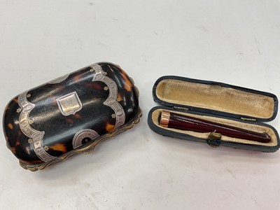 Lot 1083 - 19th century tortoiseshell and silver inlaid purse together with an Edwardian gold mounted amber cheroot holder in case