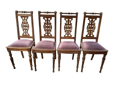 Lot 1281 - Set of four limed oak dining chairs with pierced shaped splats, padded seats and turned legs