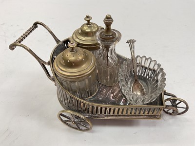 Lot 1048 - Novelty silver plated table cruet in the form of a trolley, 20cm overall length