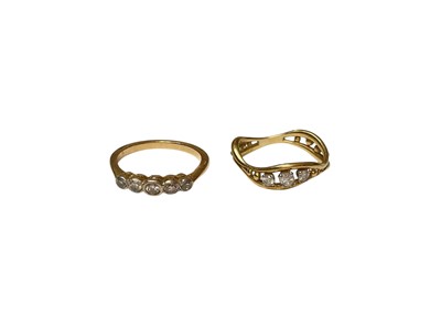 Lot 118 - Edwardian diamond five stone ring and gold diamond three stone abstract wave band ring (2)