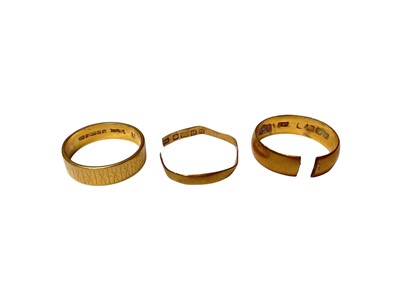 Lot 3 - Three 22ct gold wedding rings (two cut)