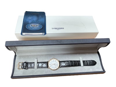 Lot 4 - Longines 18ct gold cased wristwatch with quartz movement, 32mm diameter, on black leather strap, boxed with booklet