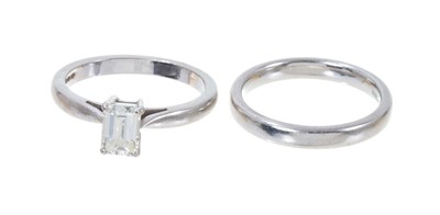 Lot 380 - Diamond single stone ring with an emerald-cut diamond estimated to weigh approximately 0.80cts in platinum setting and a platinum wedding ring