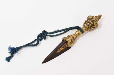 Lot 734 - Tibetan gilt bronze and steel ritual dagger / Phurba, with mask ornament, 15cm long