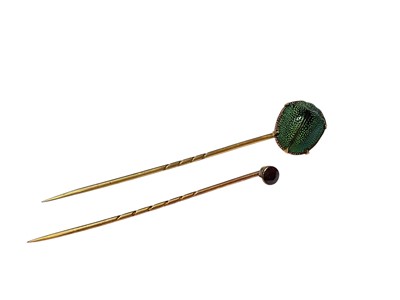 Lot 84 - Victorian yellow metal mounted beetle stick pin and an Edwardian garnet stick pin, in case