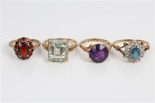 Lot 3291 - Four gold (9ct) gem set dress rings