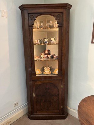 Lot 1255 - Antique mahogany two-height corner cupboard, painted interior with three shaped shelves above a single cupboard below, 197cm high