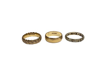 Lot 9 - Two 9ct gold wedding rings and 9ct gold gem set eternity ring (3)