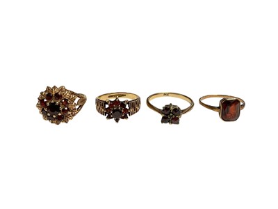 Lot 10 - Four 9ct gold garent dress rings