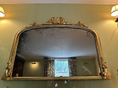 Lot 1267 - Victorian gilt framed wall mirror of arched form with foliate leaf cresting, 110cm wide x 74cm high