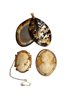 Lot 31 - Two carved shell cameos depicting classical female busts, both in 9ct gold brooch mounts, together with a tortoise shell effect mirror pendant (3)