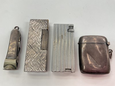 Lot 1004 - Dunhill silver plated lighter with textured finish, one other lighter, silver mounted cigar cutter and a silver vesta case (4)
