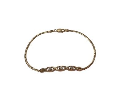Lot 1012 - 9ct gold bracelet set with three single cut diamonds in a cross-over setting on chain