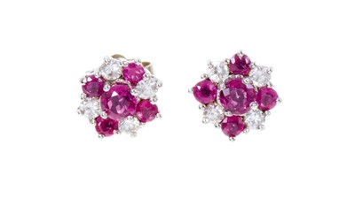 Lot 485 - Pair of ruby and diamond flower head cluster earrings in 18ct white gold setting
