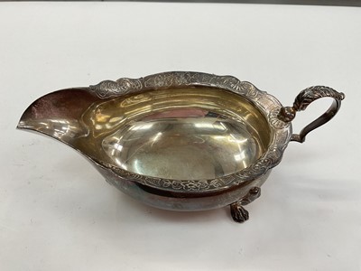 Lot 1040 - 1930s Scottish silver sauce boat with engraved floral scroll decoration to the border and four paw feet, by Mackay & Chisholm (Edinburgh 1932)