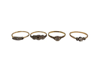 Lot 1094 - Three 18ct gold diamond rings in platinum settings and a yellow metal diamond three stone ring (4)