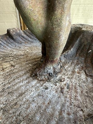 Lot 1279 - Antique cast iron bird bath mounted with a putto standing with a shell, a bird to the rim, 56cm high