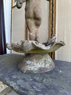 Lot 1279 - Antique cast iron bird bath mounted with a putto standing with a shell, a bird to the rim, 56cm high