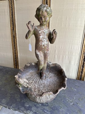 Lot 1279 - Antique cast iron bird bath mounted with a putto standing with a shell, a bird to the rim, 56cm high