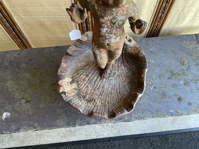 Lot 1279 - Antique cast iron bird bath mounted with a putto standing with a shell, a bird to the rim, 56cm high